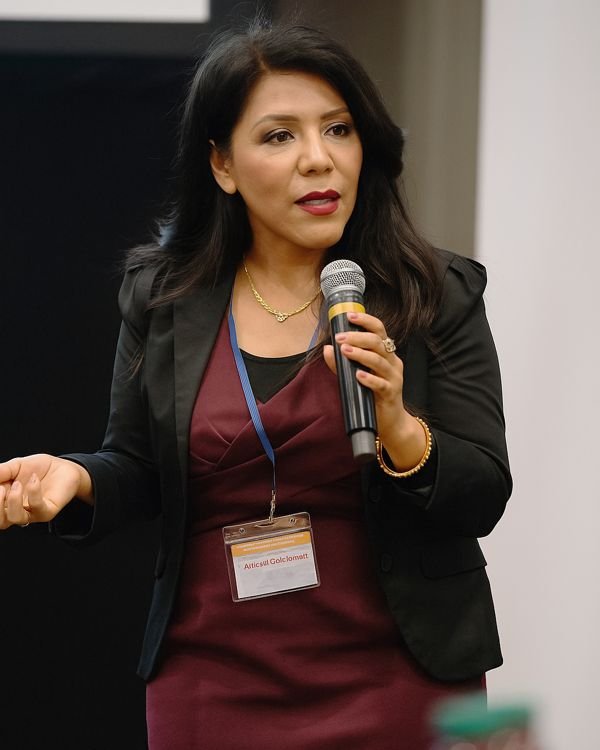 Araceli giving a public speech at a conference